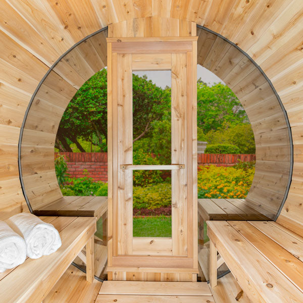 Tranquility MP Barrel Sauna indoor view facing front door, shows windows, indoor and outdoor seating