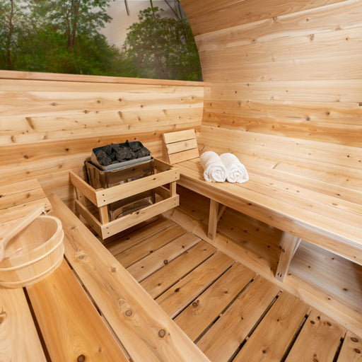 Tranquility MP Barrel Sauna inside view showing heating element, towels, bucket, benches, and rear side window
